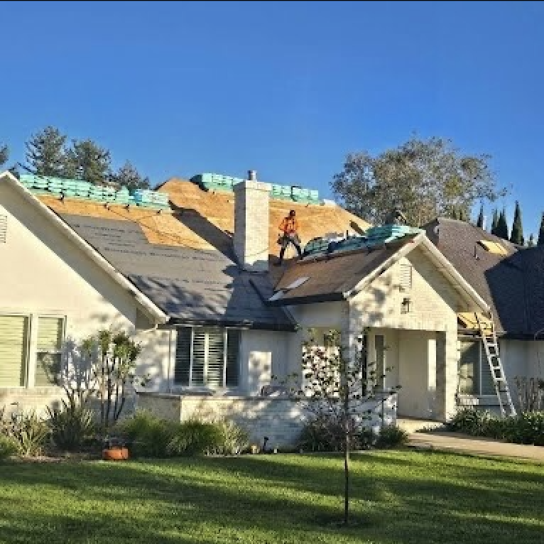 Sacramento roof replacement in progress with materials staged
