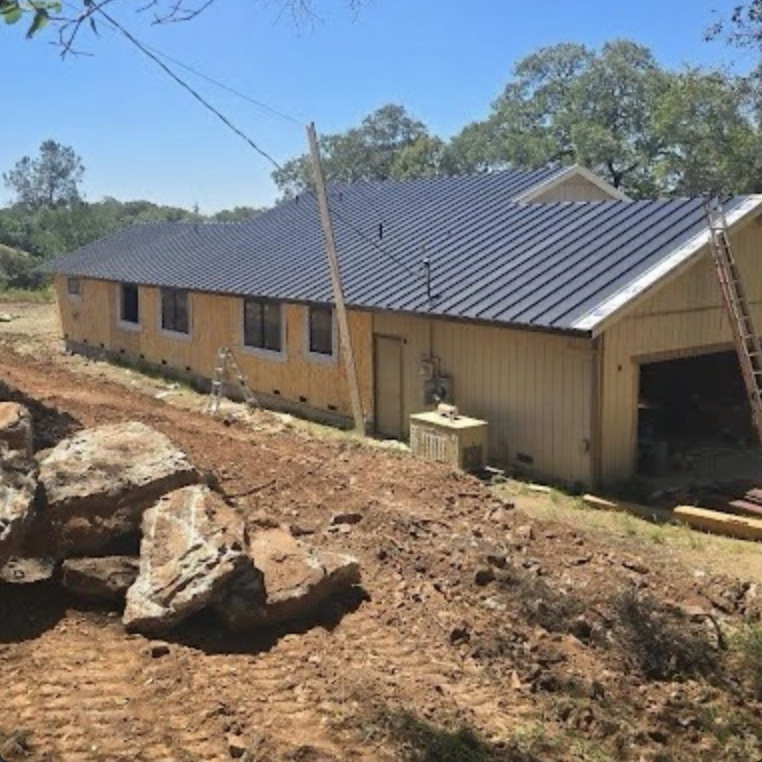 New-construction Sacramento home with standing seam metal roof installation