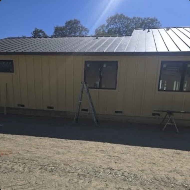 Standing seam metal roofing installed above James Hardie siding in Sacramento, CA