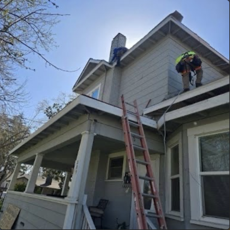 Roofing crew accessing a two-story home for roof work
