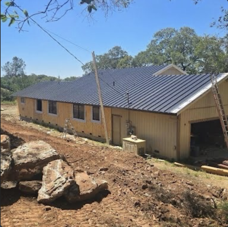 Completed dark metal roof on residential building
